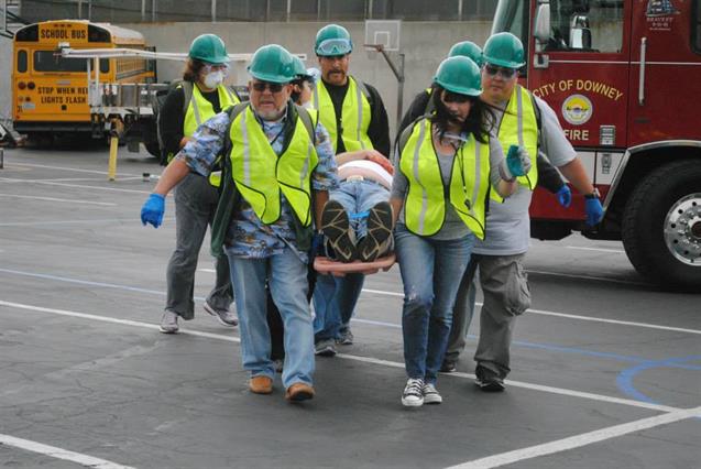 Volunteers carrying person on stretcher