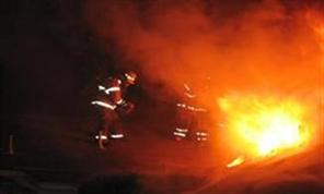 Firefighters fighting fire at night